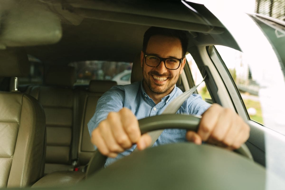 Showcasing a driver smiling while driving